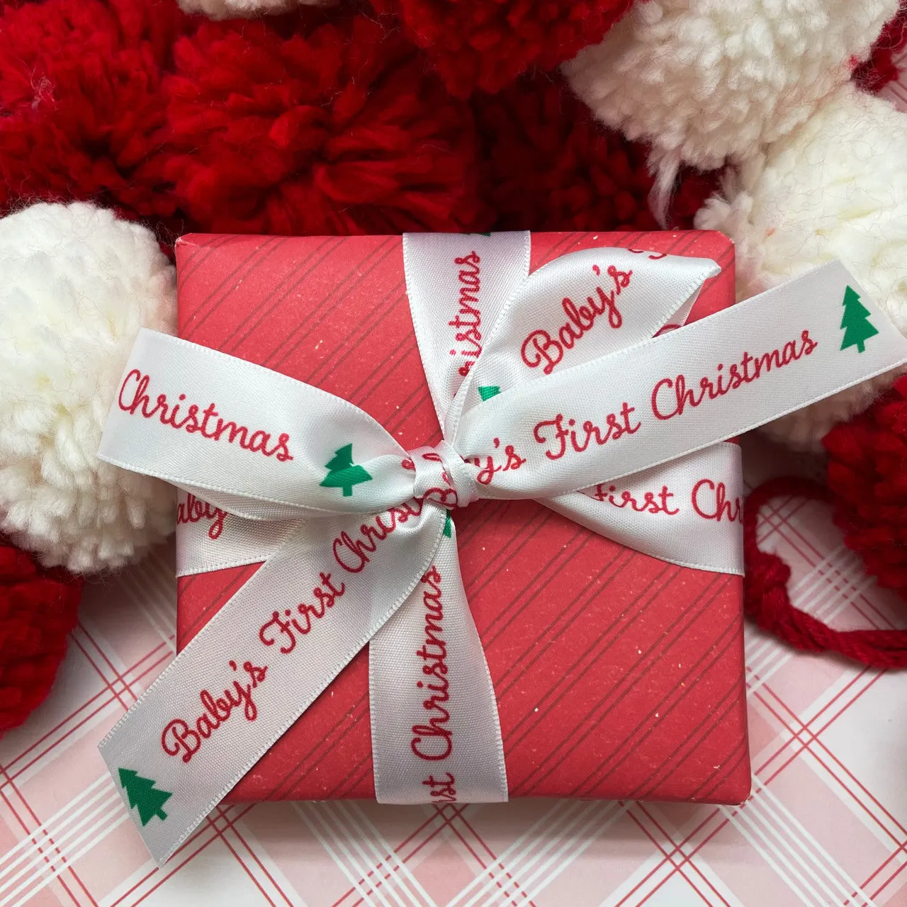 Baby's First Christmas Ribbon in red with a green Christmas tree printed on 7/8" white single face satin
